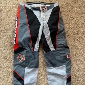 Padded Arctic Cat snowmobiling pants.